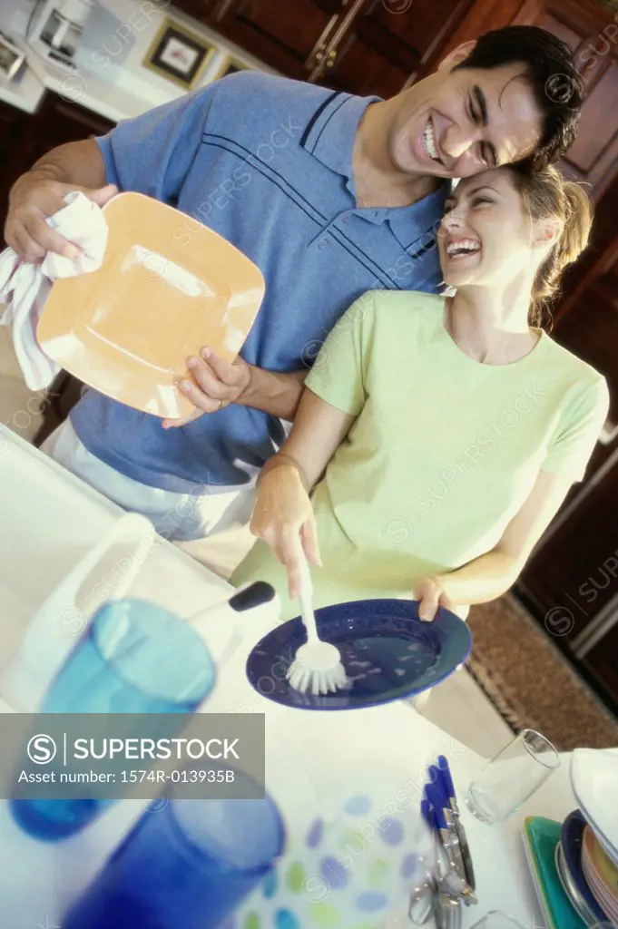 Young man helping a young woman in a kitchen
