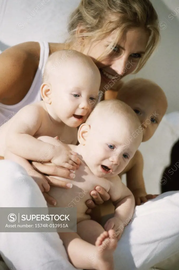 Close-up of a mother holding her three sons