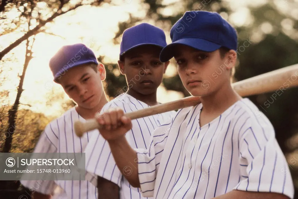 Portrait of three baseball players with a baseball bat