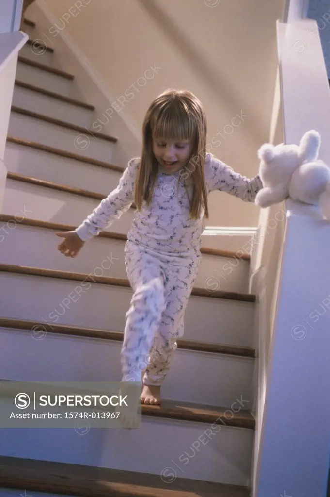 Low angle view of a girl walking down stairs