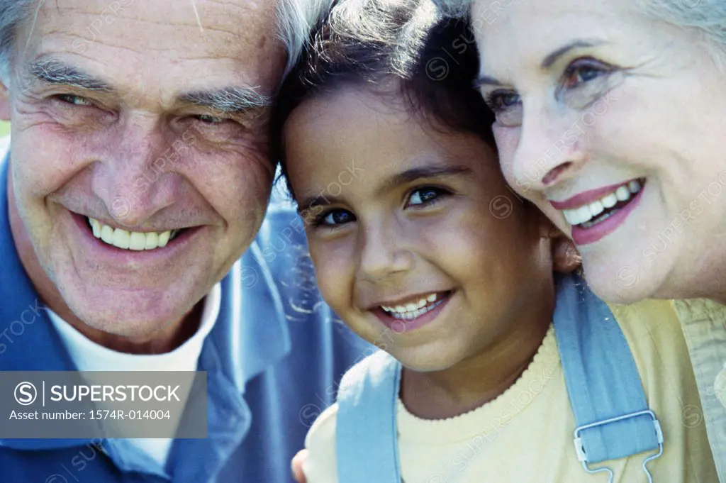 Portrait of a granddaughter smiling with her grandparents