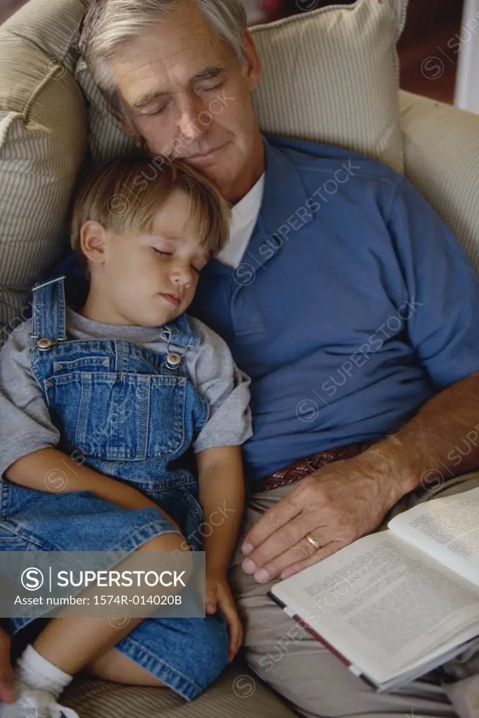 Boy sleeping with his grandfather