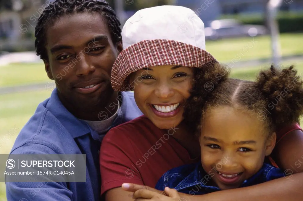Portrait of parents with their daughter smiling