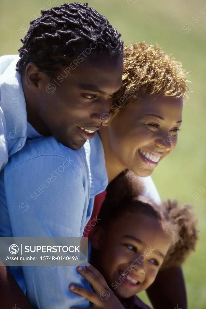 Side profile of parents and their daughter smiling