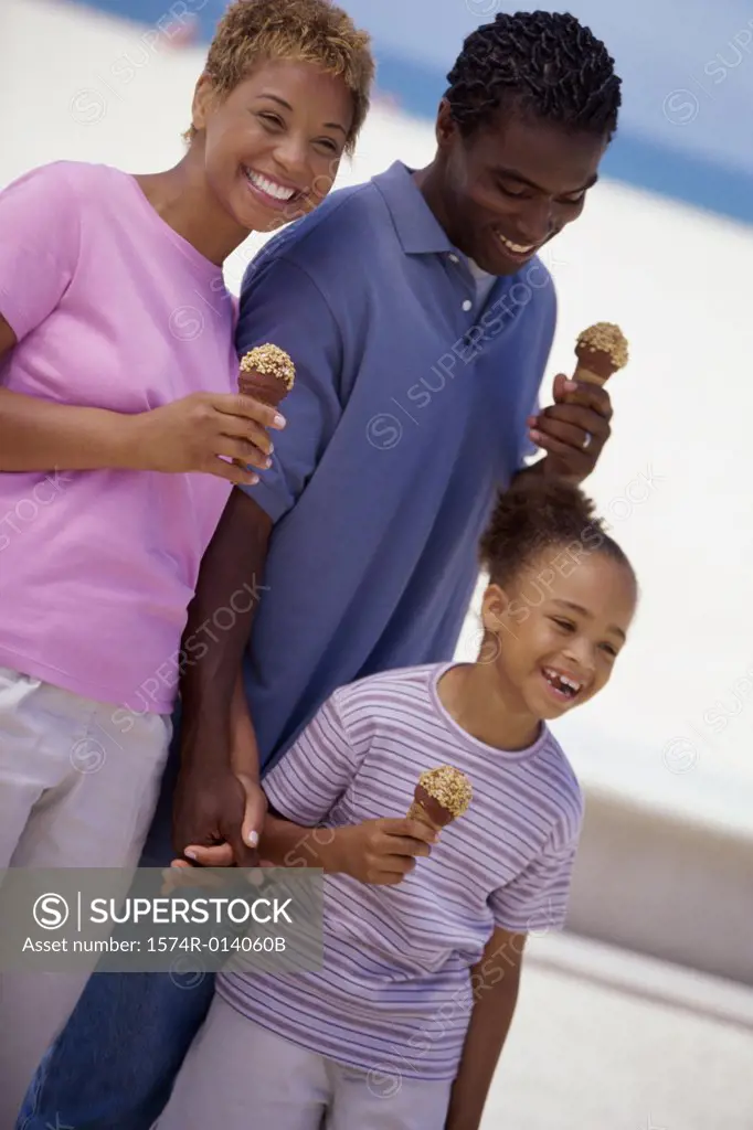 Parents and their daughter holding ice cream cones and smiling