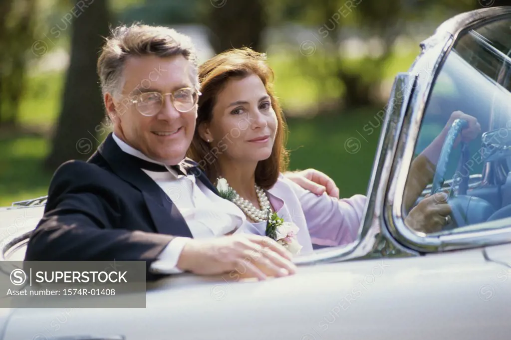 Portrait of a couple sitting in a convertible car
