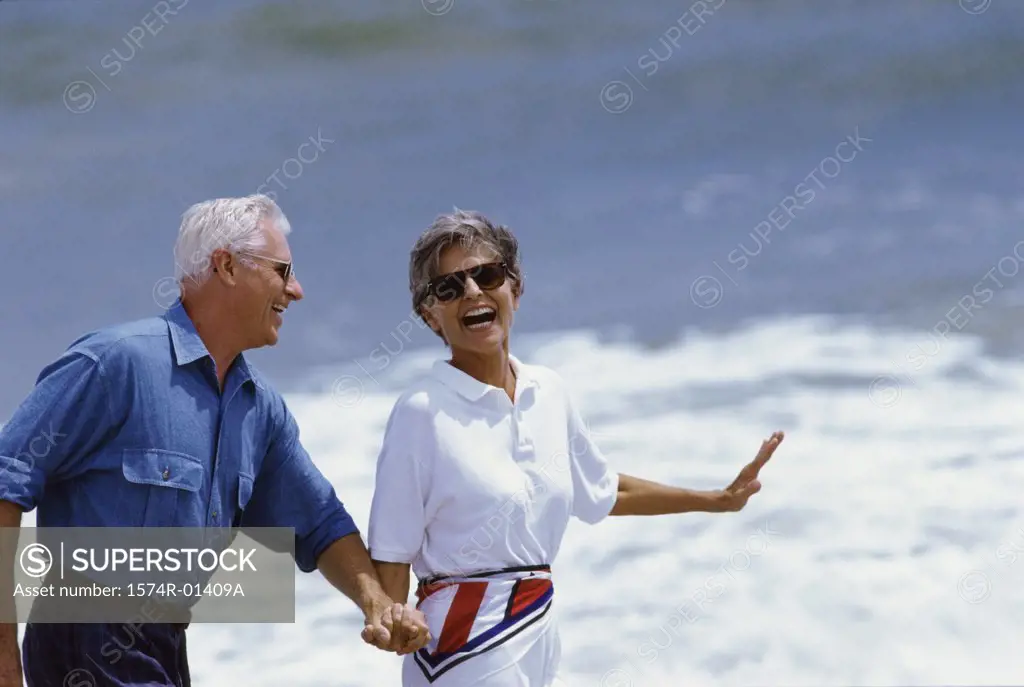 Senior couple walking at the beach