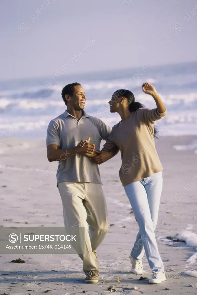 Mid adult couple walking on the beach