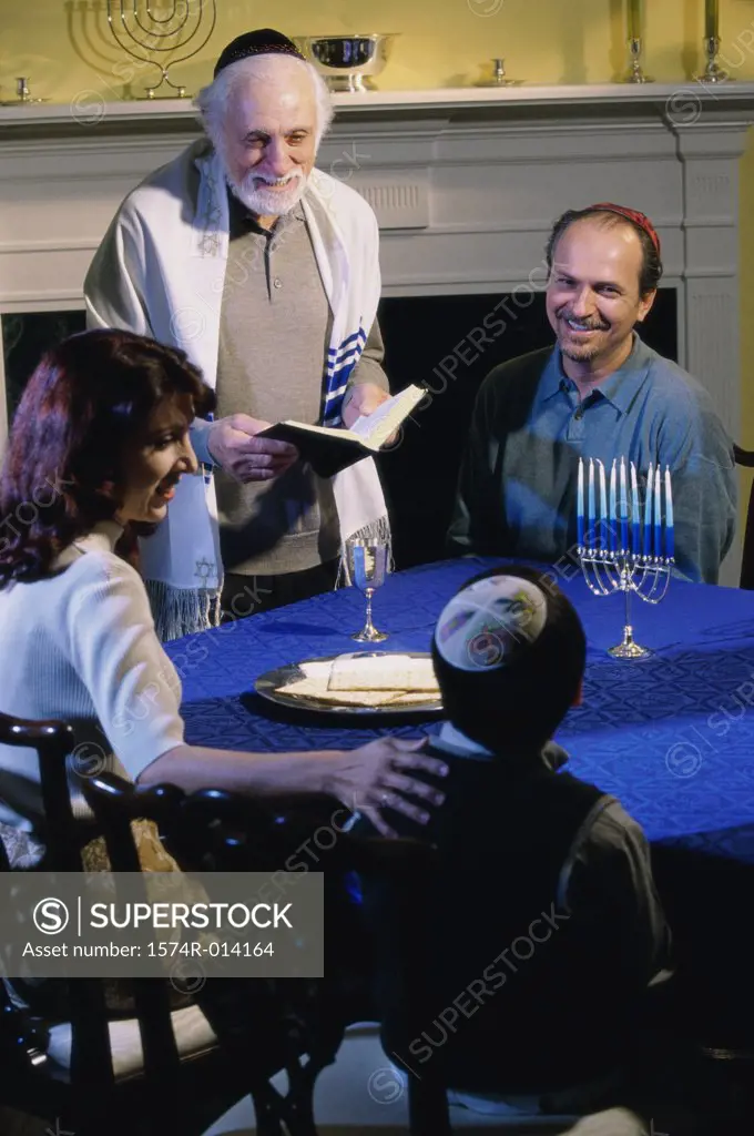 Parents and their son and a rabbi at a Hanukkah ceremony