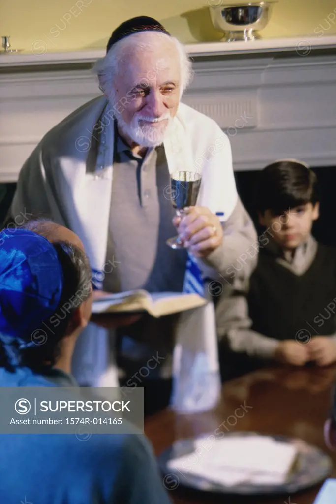 High angle view of a rabbi holding a goblet at a Hanukkah ceremony
