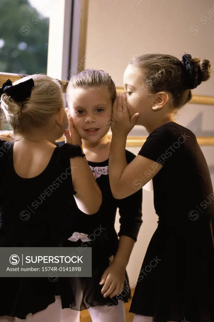 Three ballerinas whispering