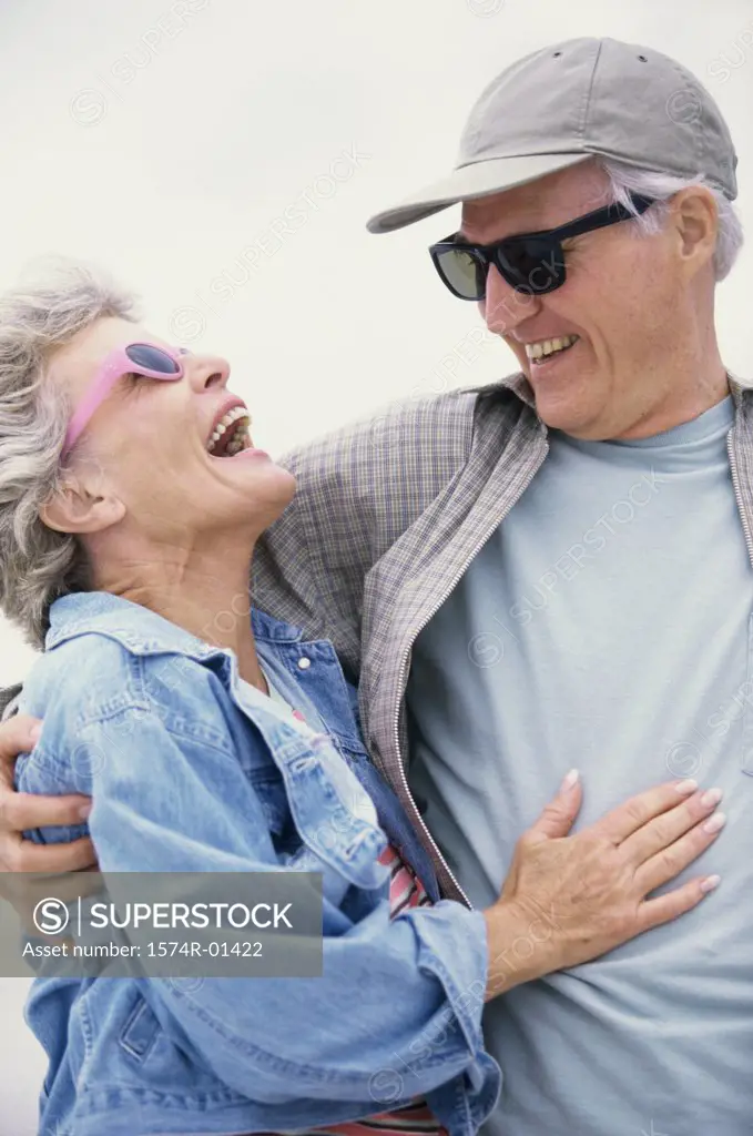 Portrait of a senior couple holding each other laughing