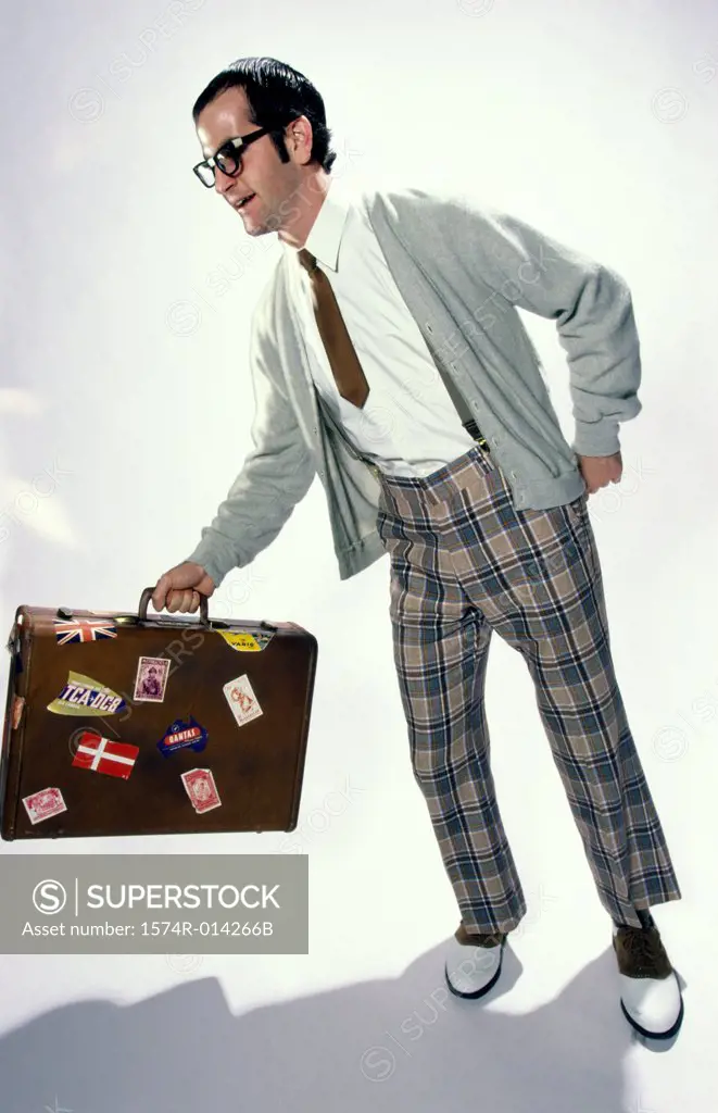 Young man holding a suitcase