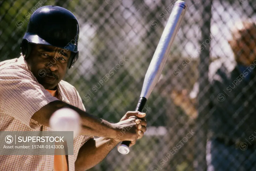Close-up of a senior man playing baseball