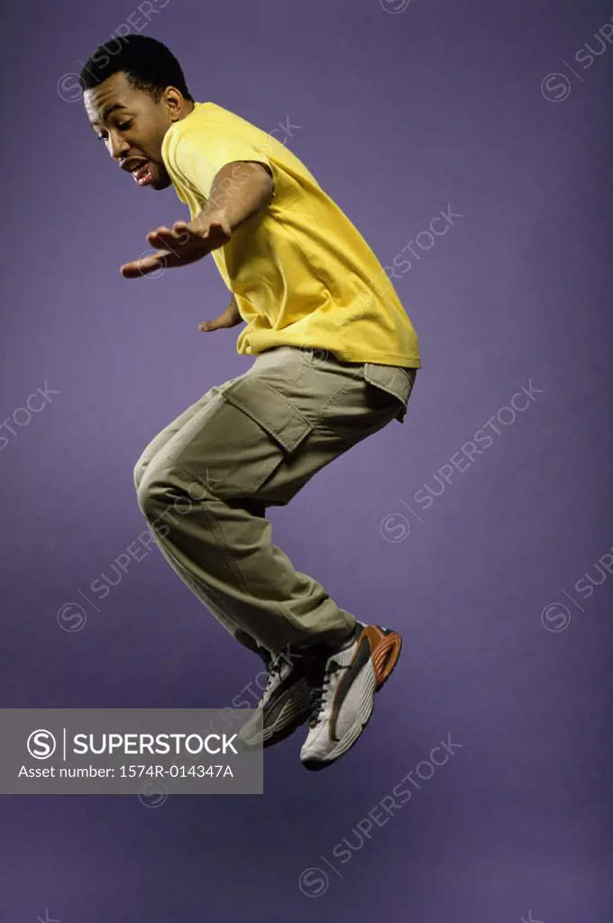 Side profile of a young man jumping