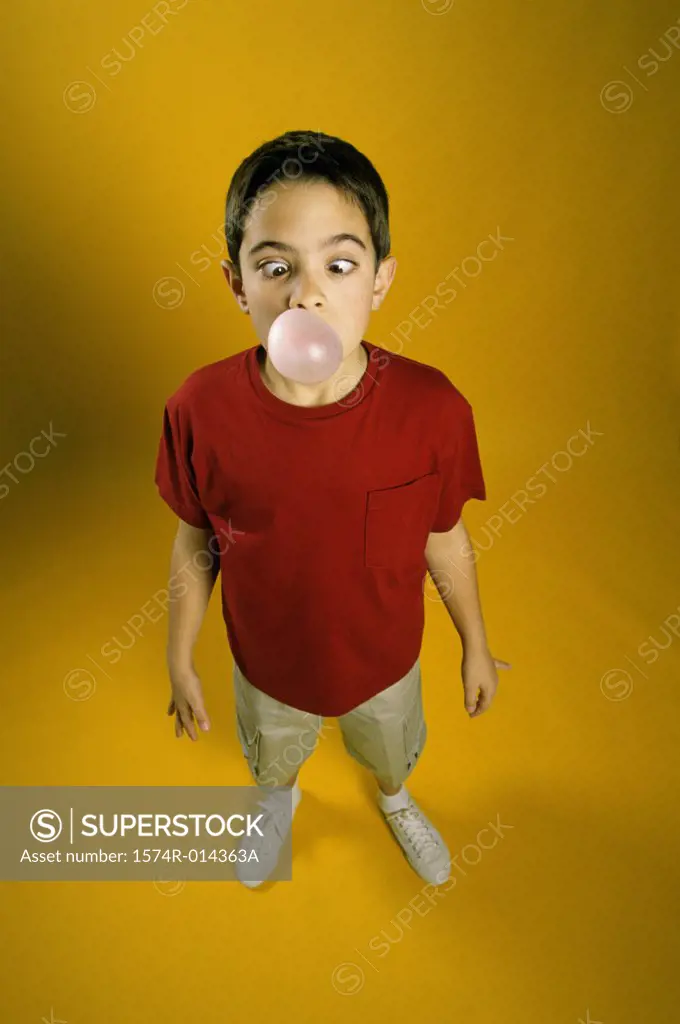 High angle view of a boy blowing a bubble