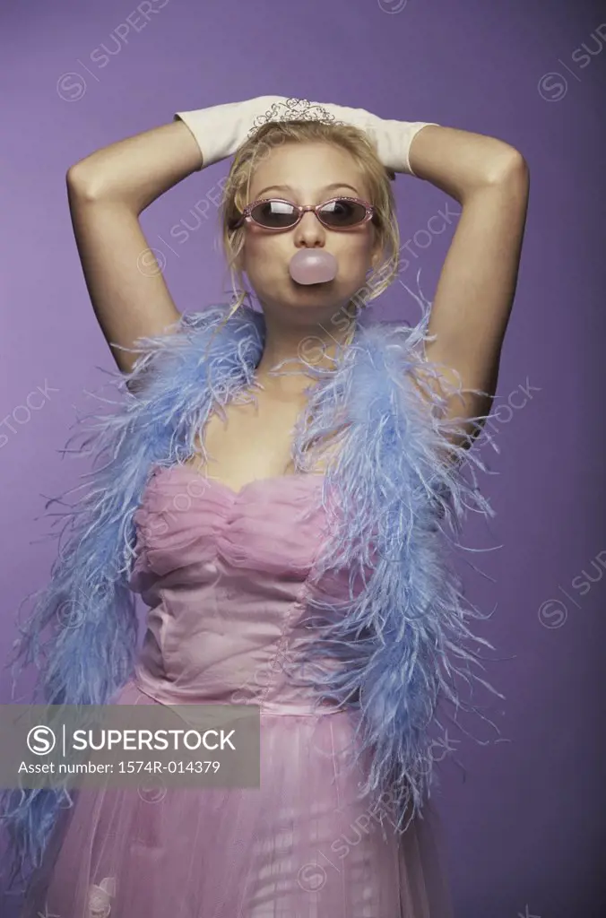 Portrait of a young woman blowing bubble gum