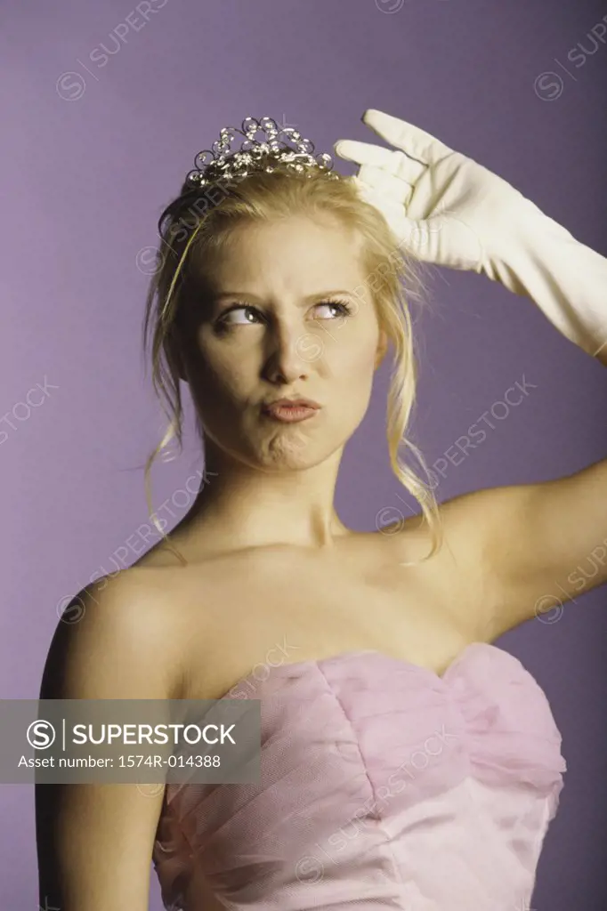 Close-up of a teenage girl adjusting her tiara