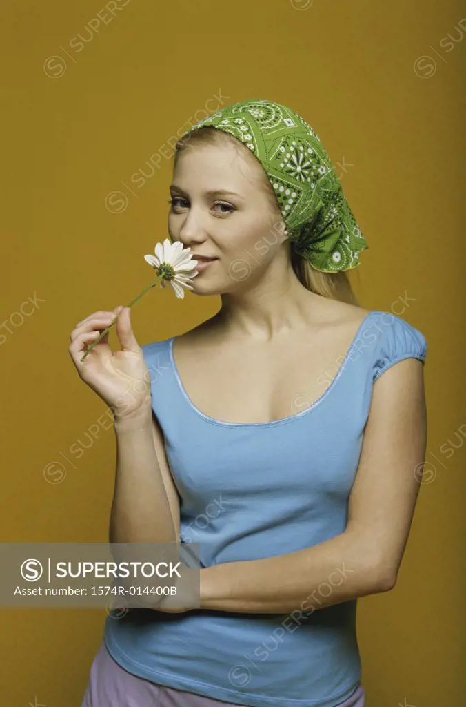 Portrait of a teenage girl holding a flower