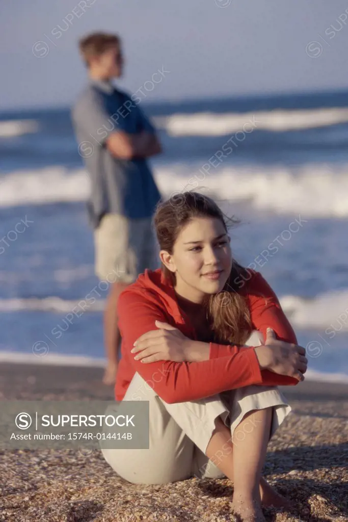 Close-up of a teenage girl sitting on the beach
