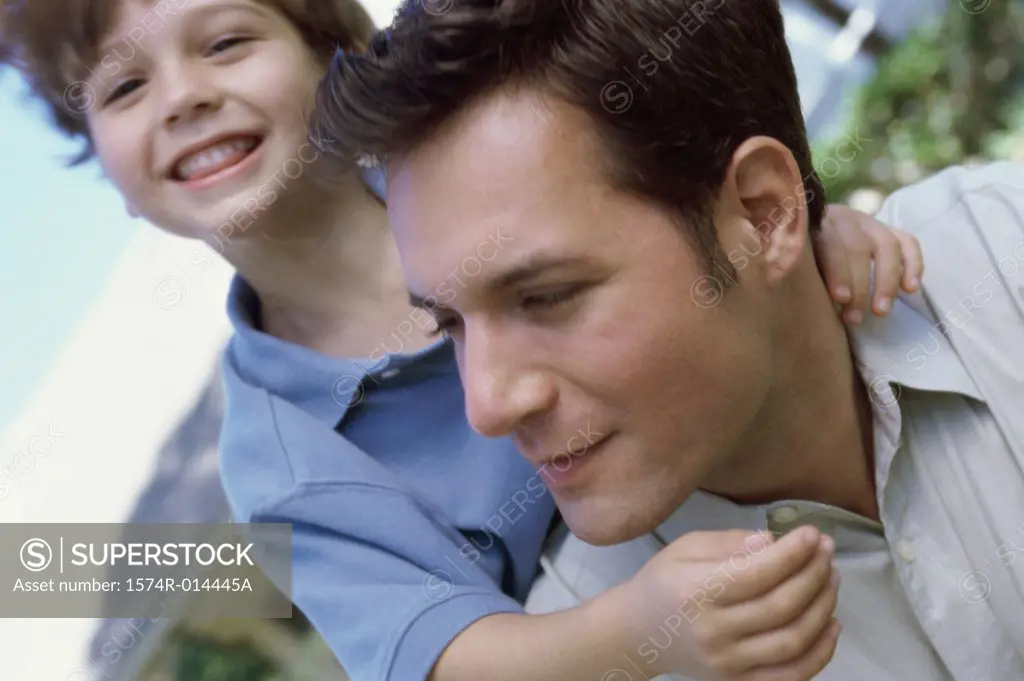 Close-up of a father and son smiling