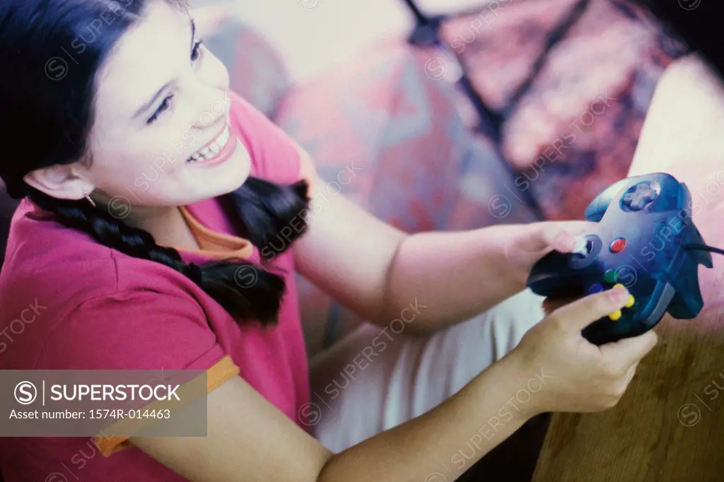 High angle view of a teenage girl playing video games