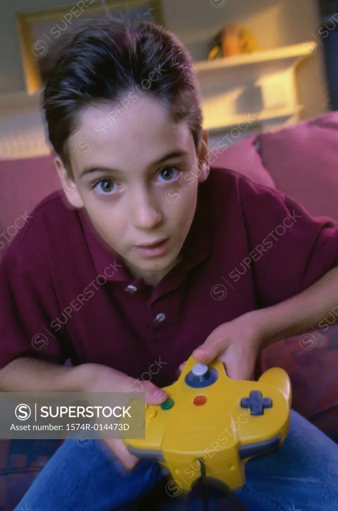 Portrait of a teenage boy playing video games