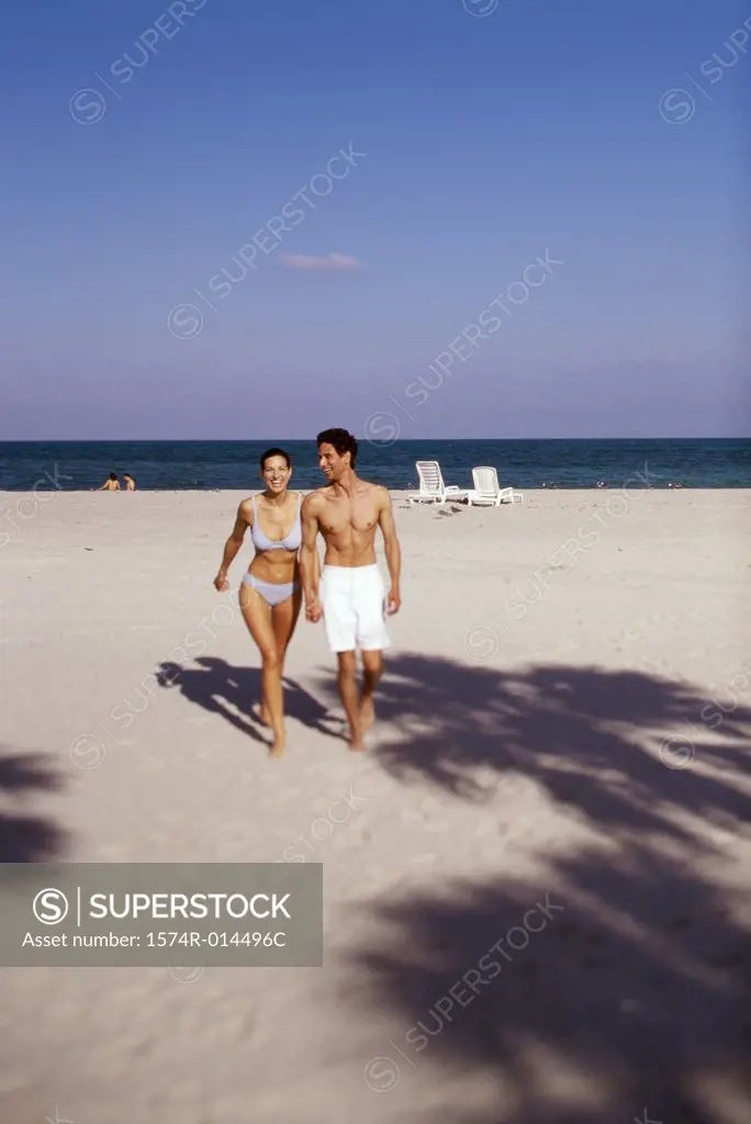 Young couple walking on the beach