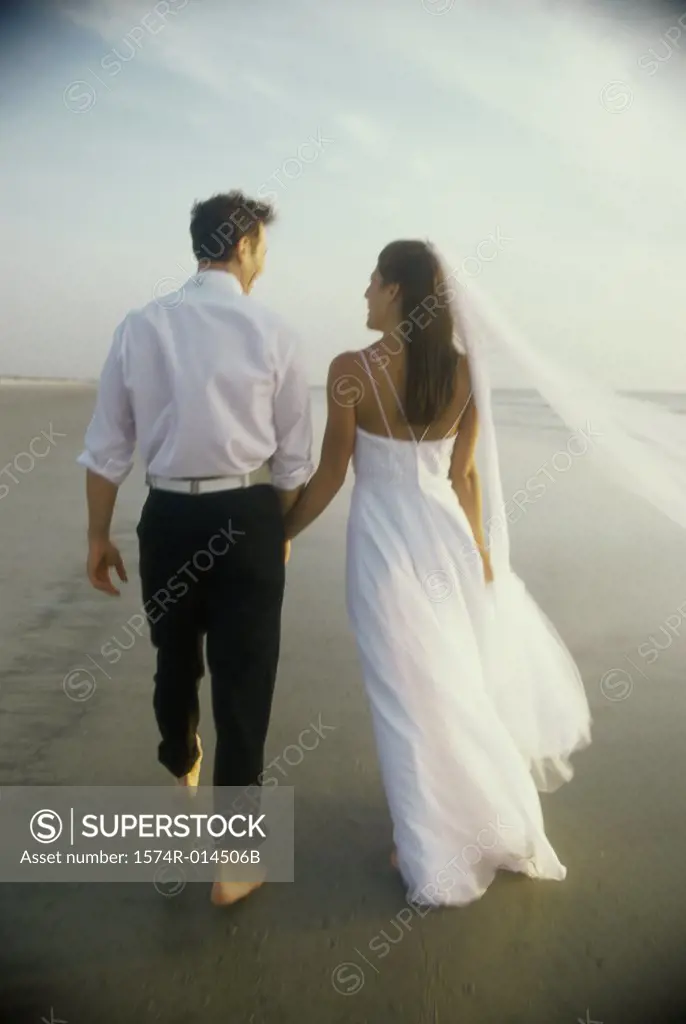 Rear view of a newlywed couple on the beach
