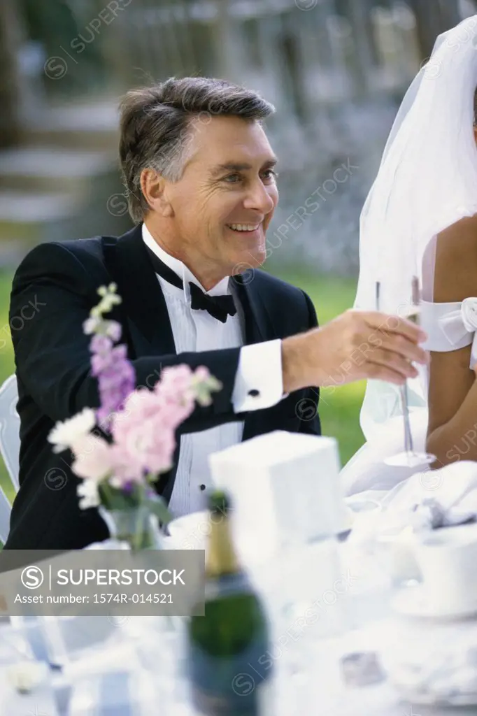Mature man toasting with champagne at a wedding reception