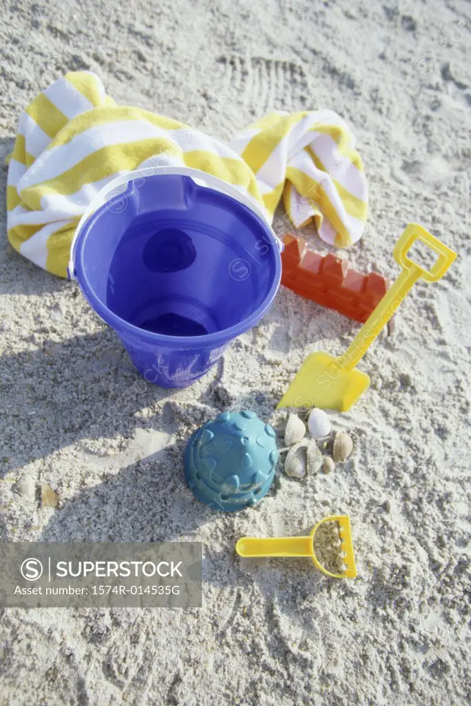High angle view of a sand pail and a shovel on the beach