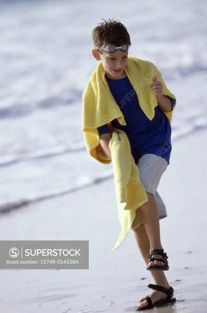 Boy stepping on the beach