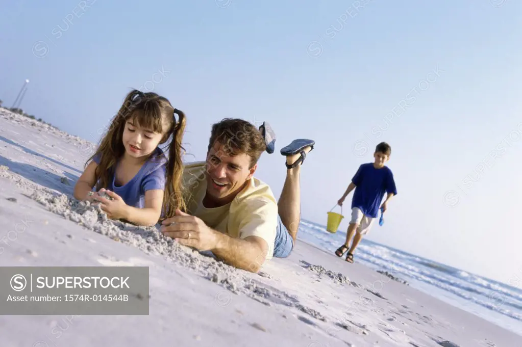 Father with his children on the beach