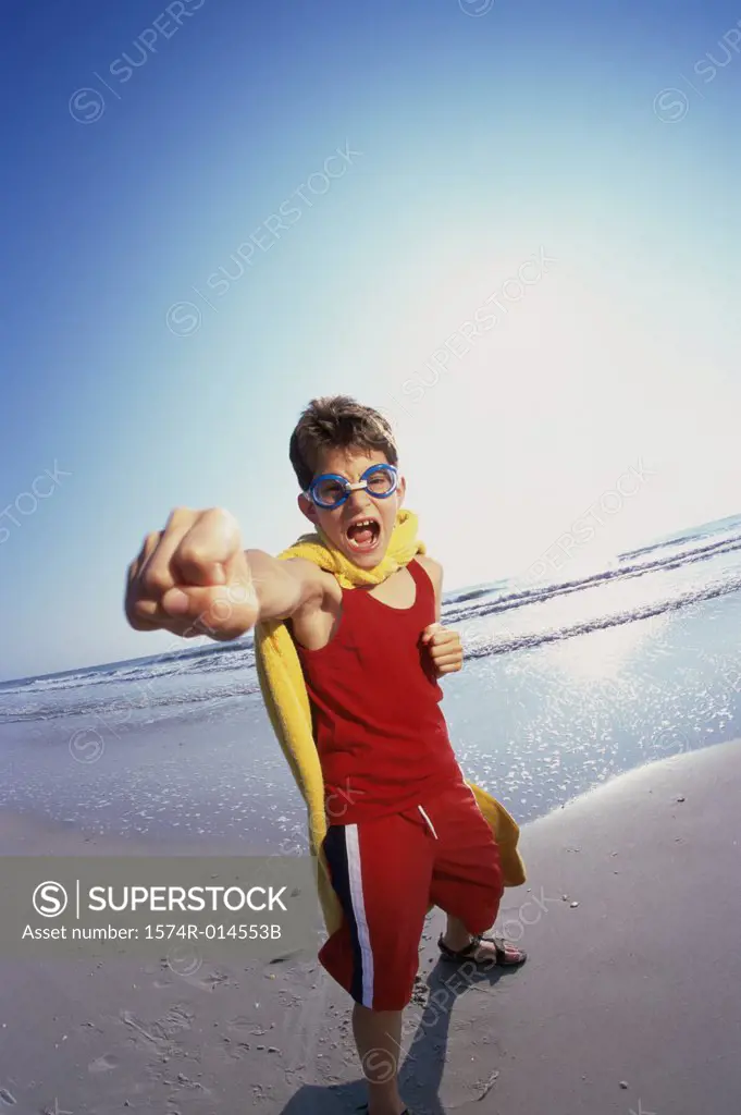 Portrait of a boy punching on the beach