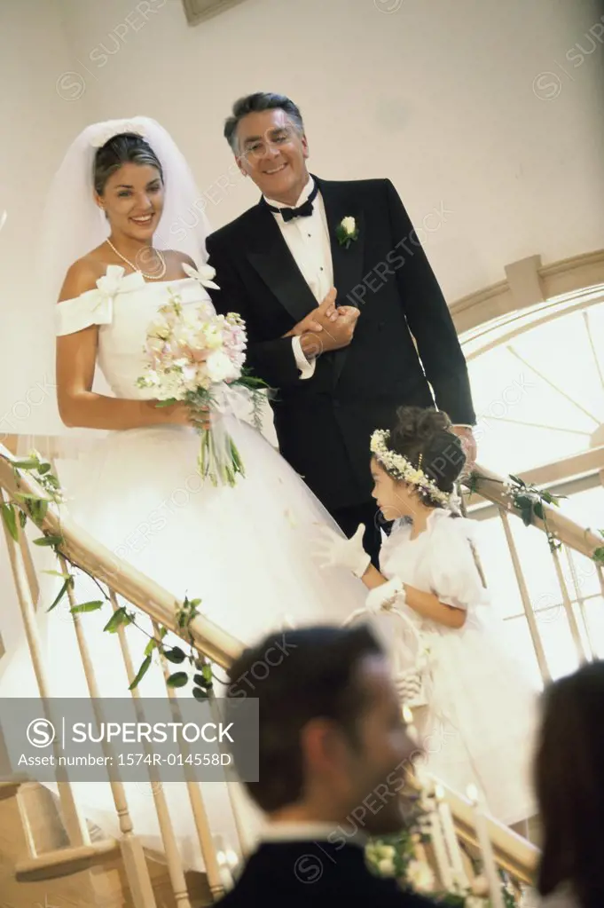 Bride walking down stairs with her father