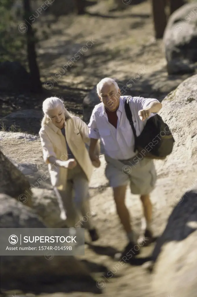 Senior couple hiking over a rugged landscape
