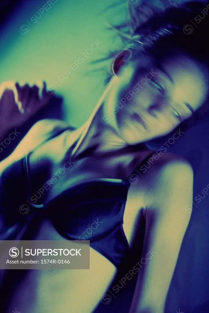 Young woman lying down wearing a bra