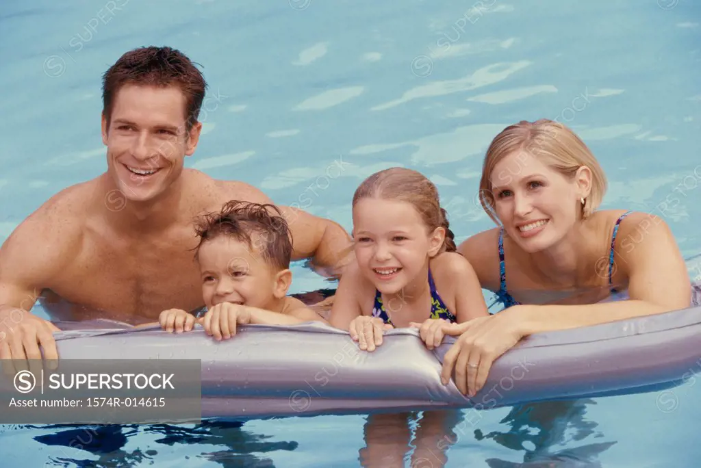 Parents and their two children in a swimming pool
