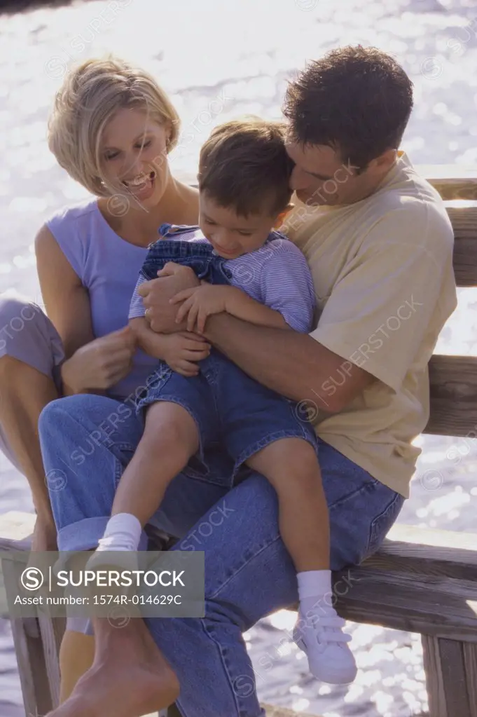 Parents and their son sitting on a bench