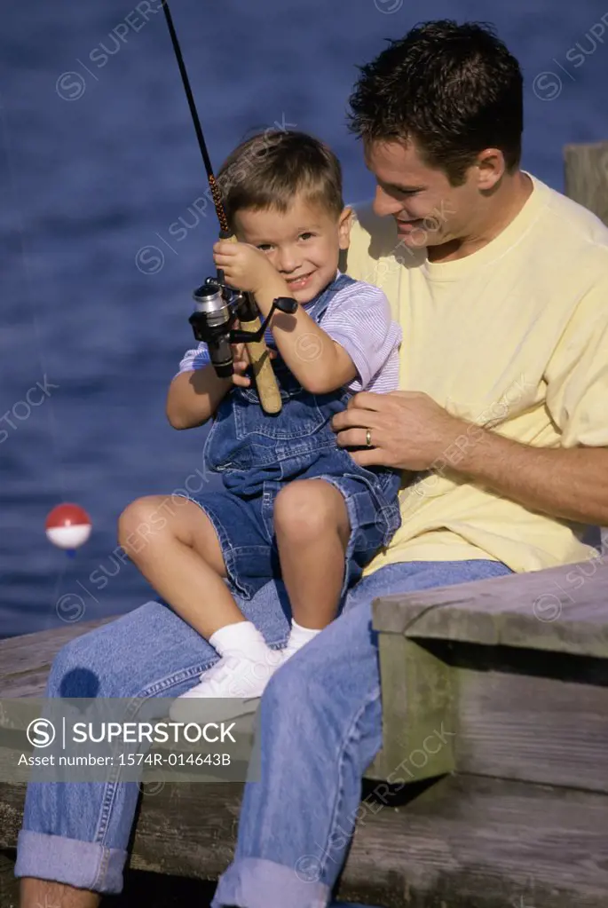Father teaching his son to fish