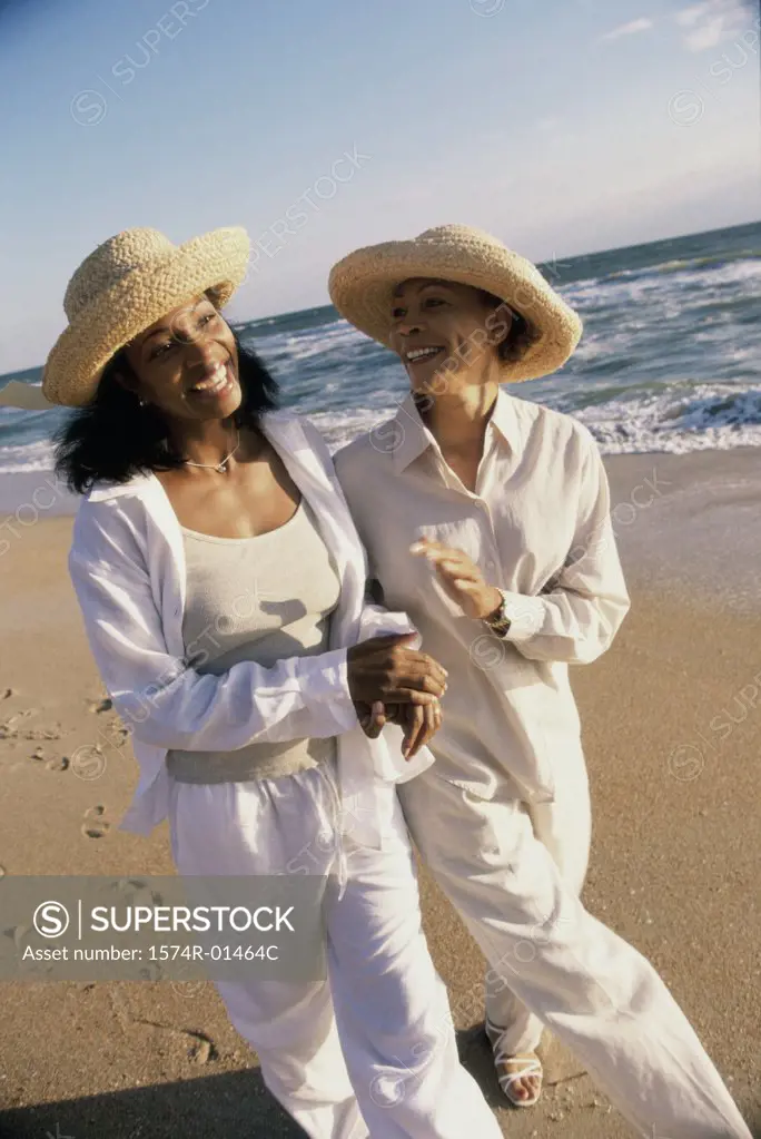 Mother walking with her daughter at the beach