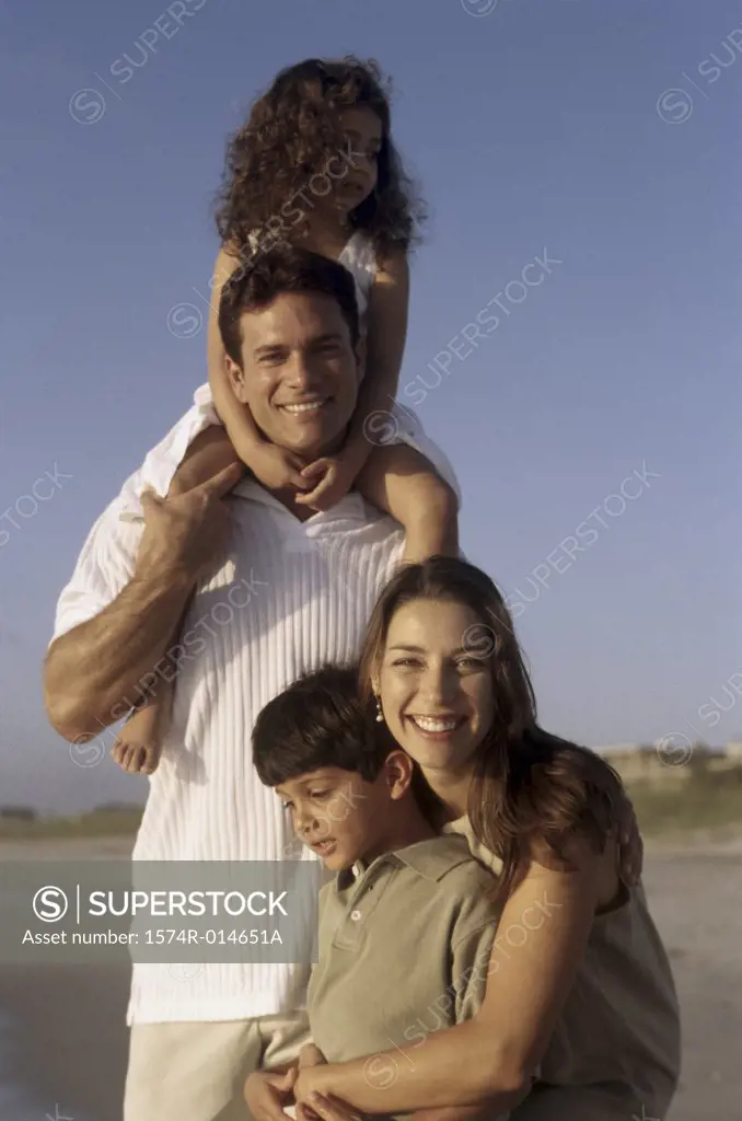 Portrait of parents and their two children on the beach
