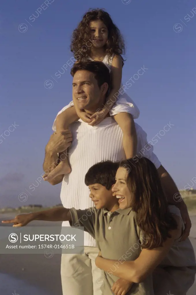 Portrait of parents and their two children on the beach