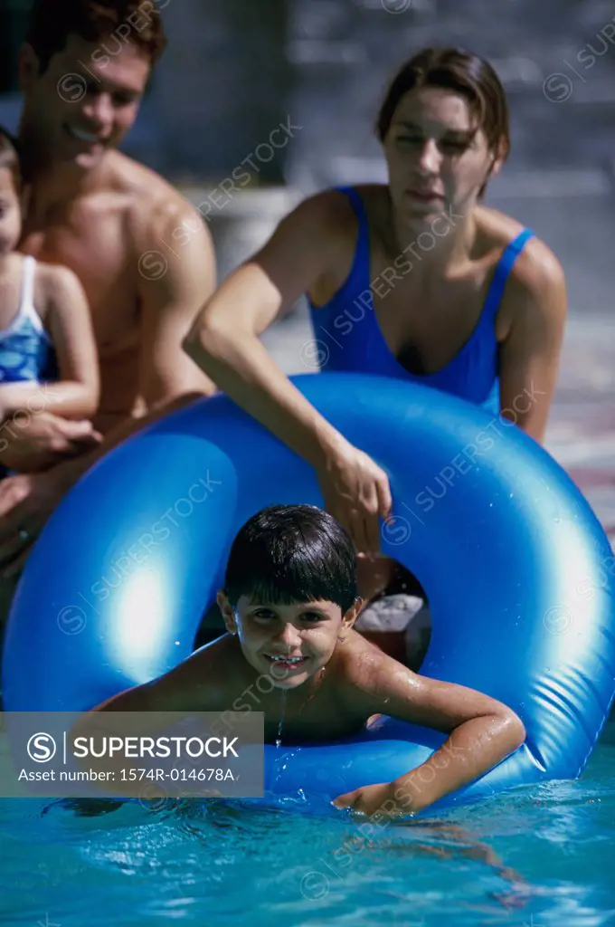 Parents and their two children playing in a swimming pool