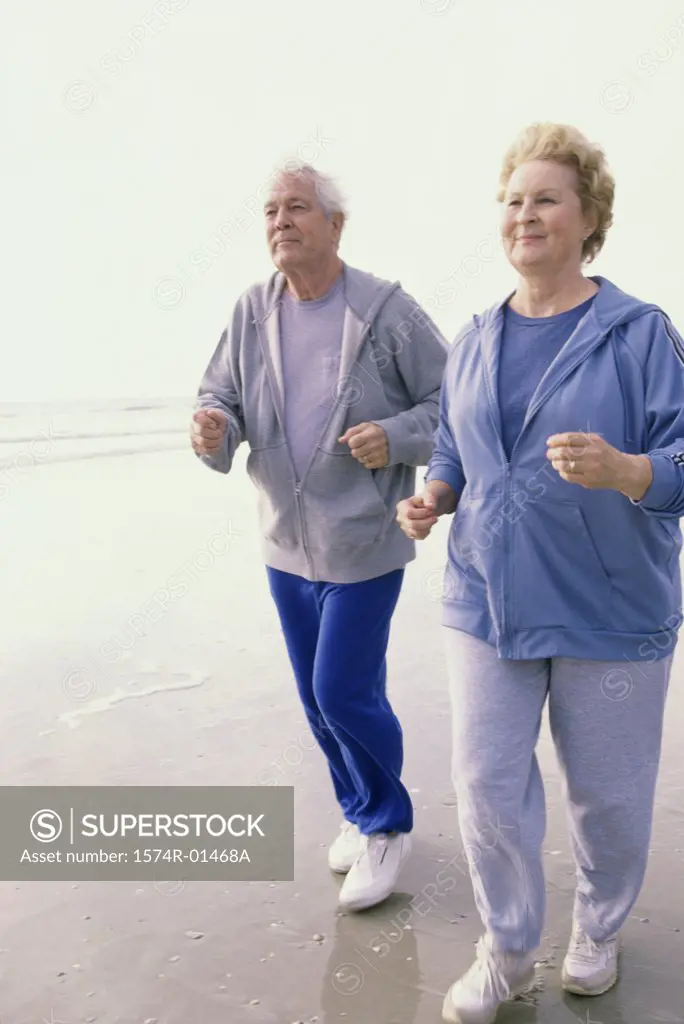 Senior couple jogging at the beach