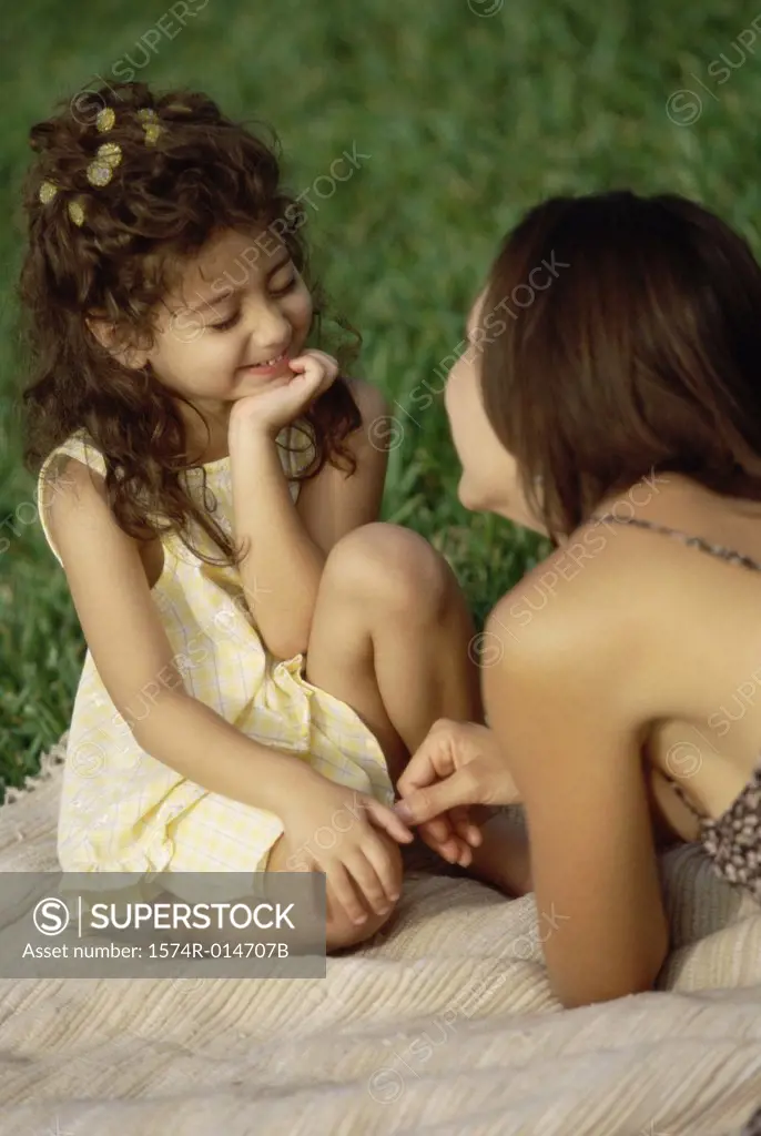 Daughter sitting with her mother in a park