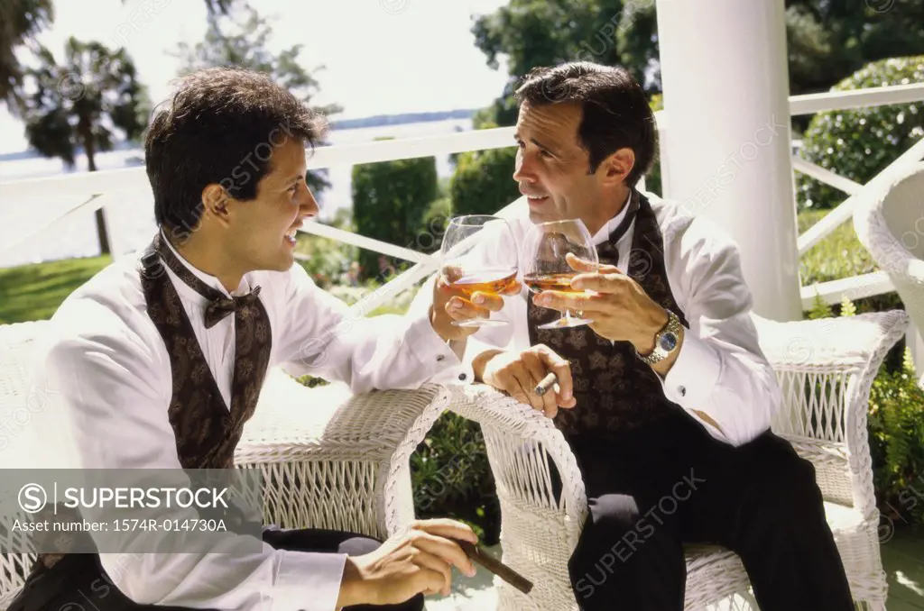 Father and his son toasting with wine