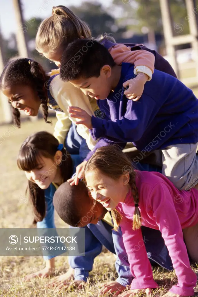 Side profile of a group of children making a human pyramid