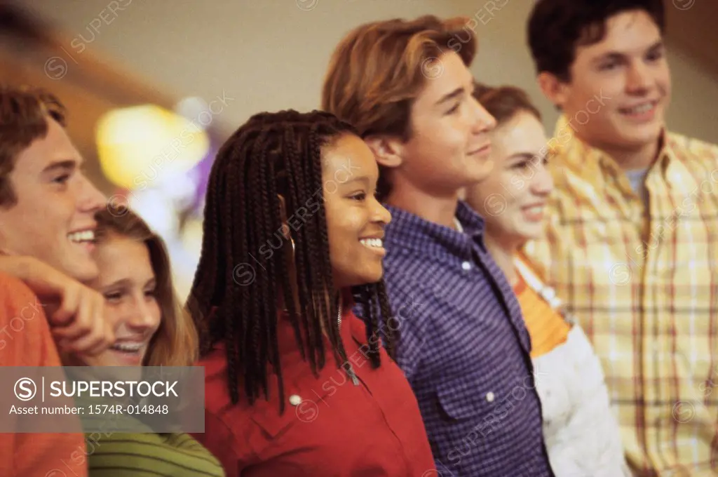 Side profile of a group of teenagers standing in a row