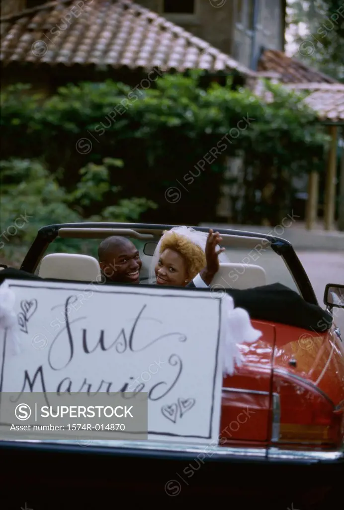 Portrait of a newlywed couple sitting in a car